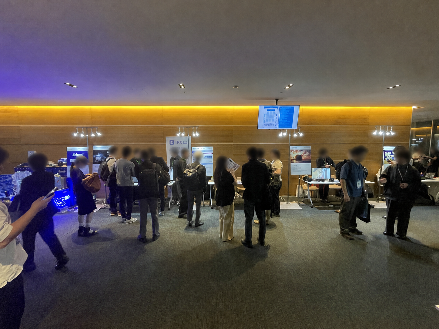 Privacy-blurred attendees exploring exhibition booths at Sony Open Innovation Day 2026.