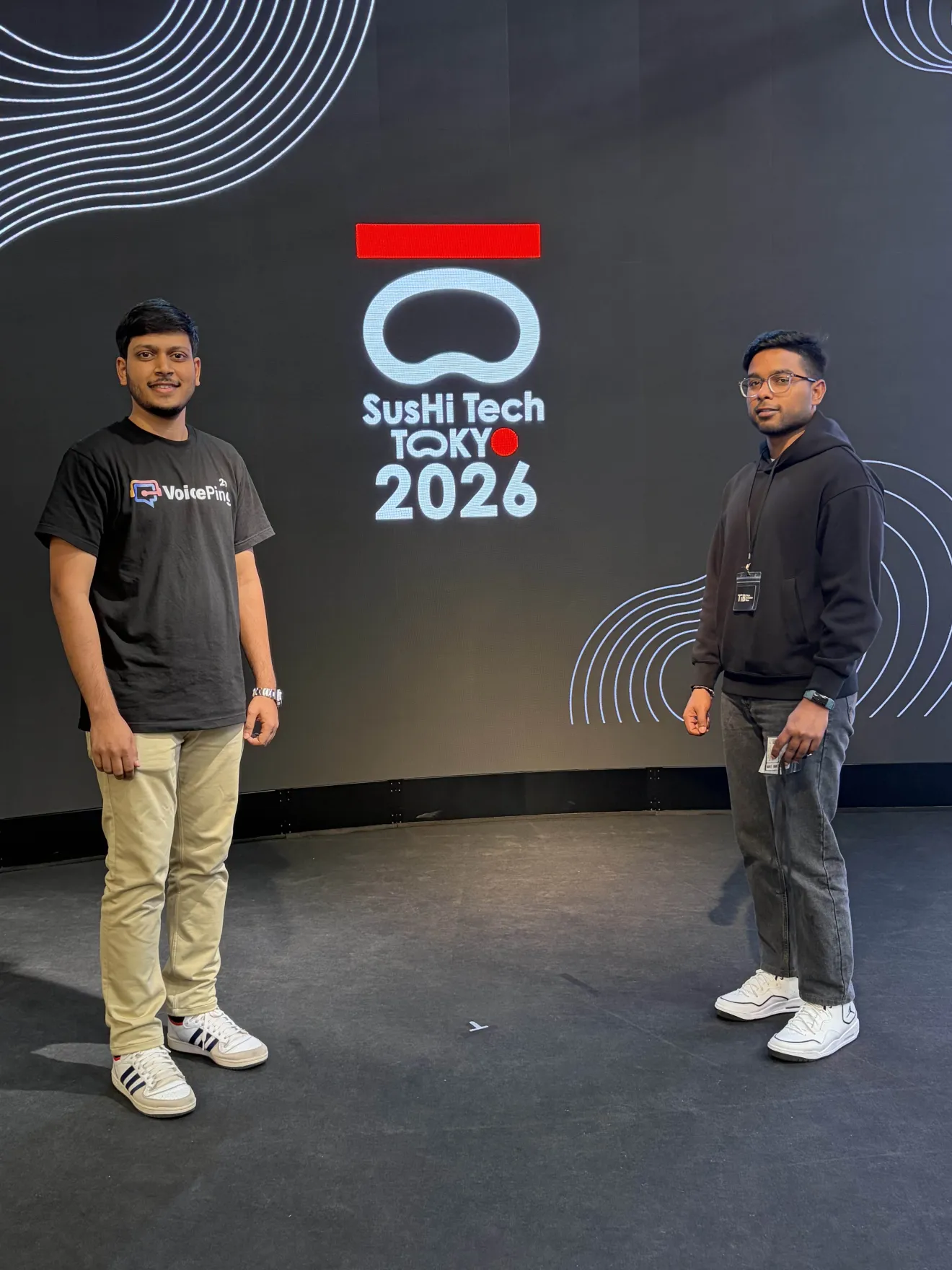 Two VoicePing team members in front of the SusHi Tech Tokyo 2026 stage